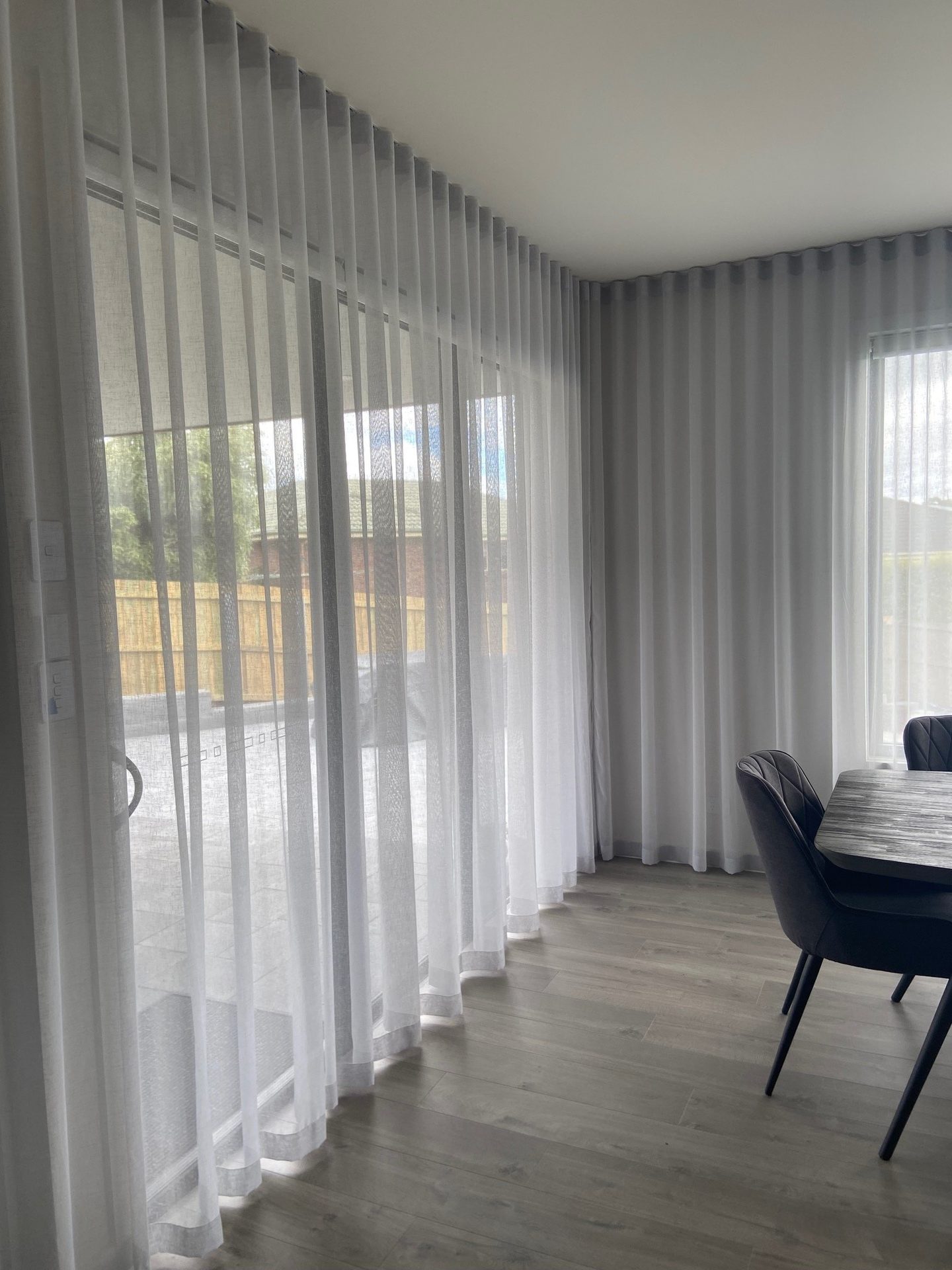 Sheer curtain gathered beside a bedroom window