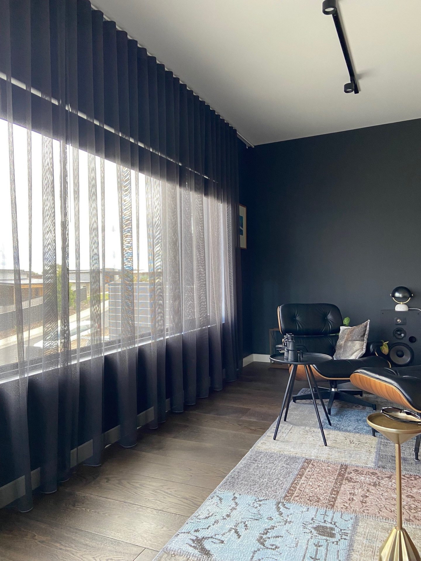 Sheer curtains framing a corner window