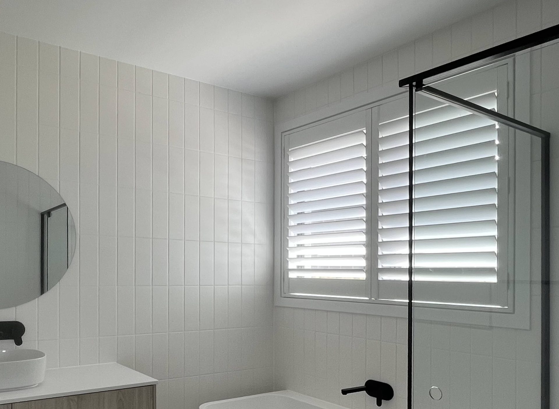 White plantation shutters fitted to a bathroom window