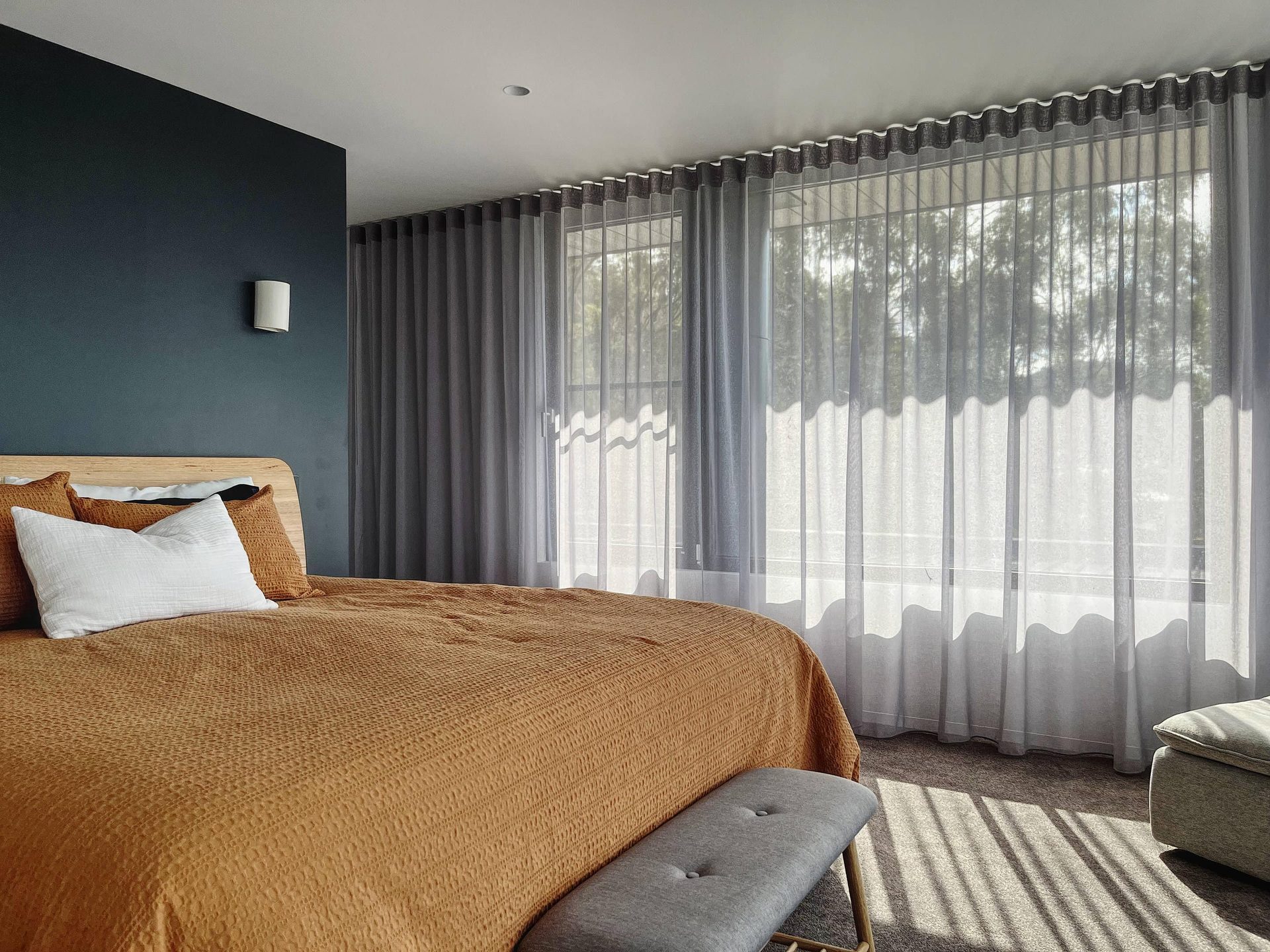 Sheer curtains drawn across a bedroom window